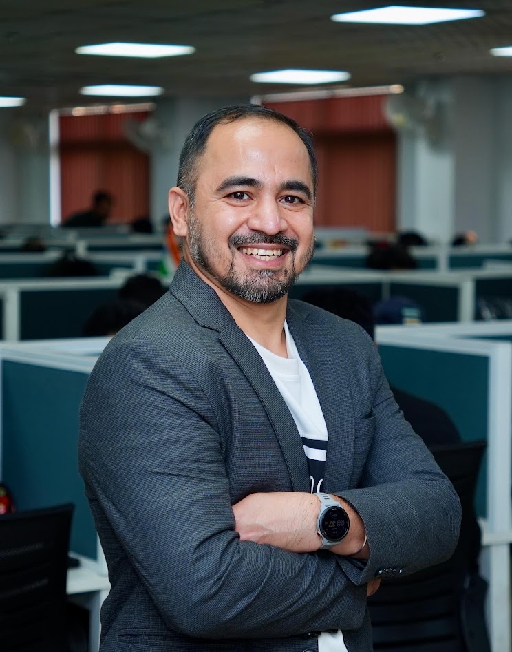 Udit Handa smiling in his Dehradun office